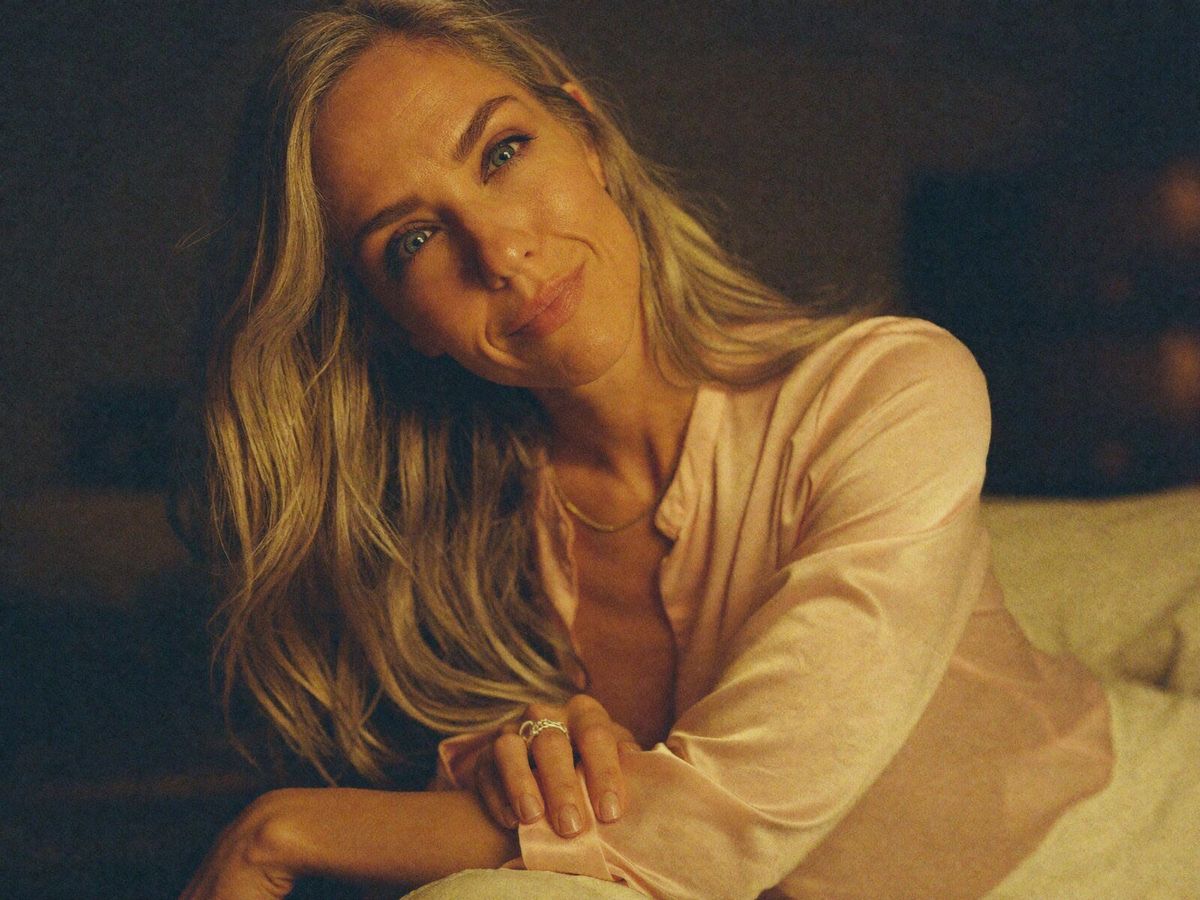 Pink top — leaning softly, warm gaze