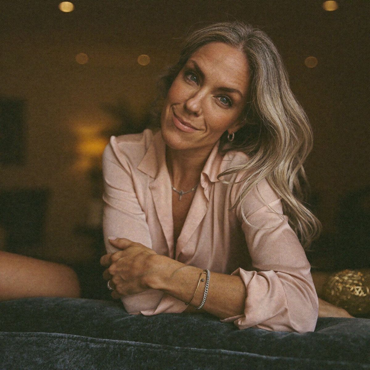 Pink blouse — couch, relaxed